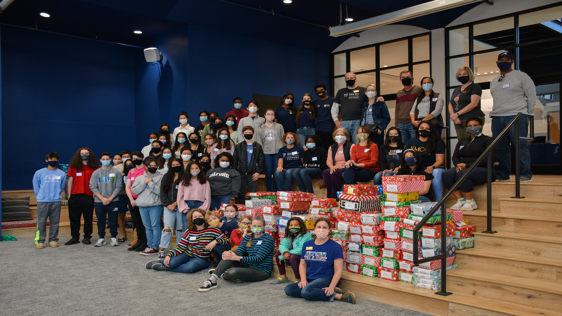 Emory Cares volunteers gather with gift boxes for children and teens in the Newton County Foster Care Program.