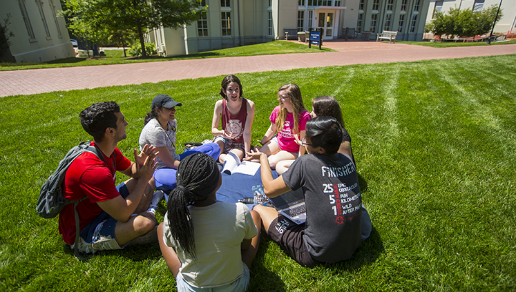 Students sit outside the Oxford College Library. 